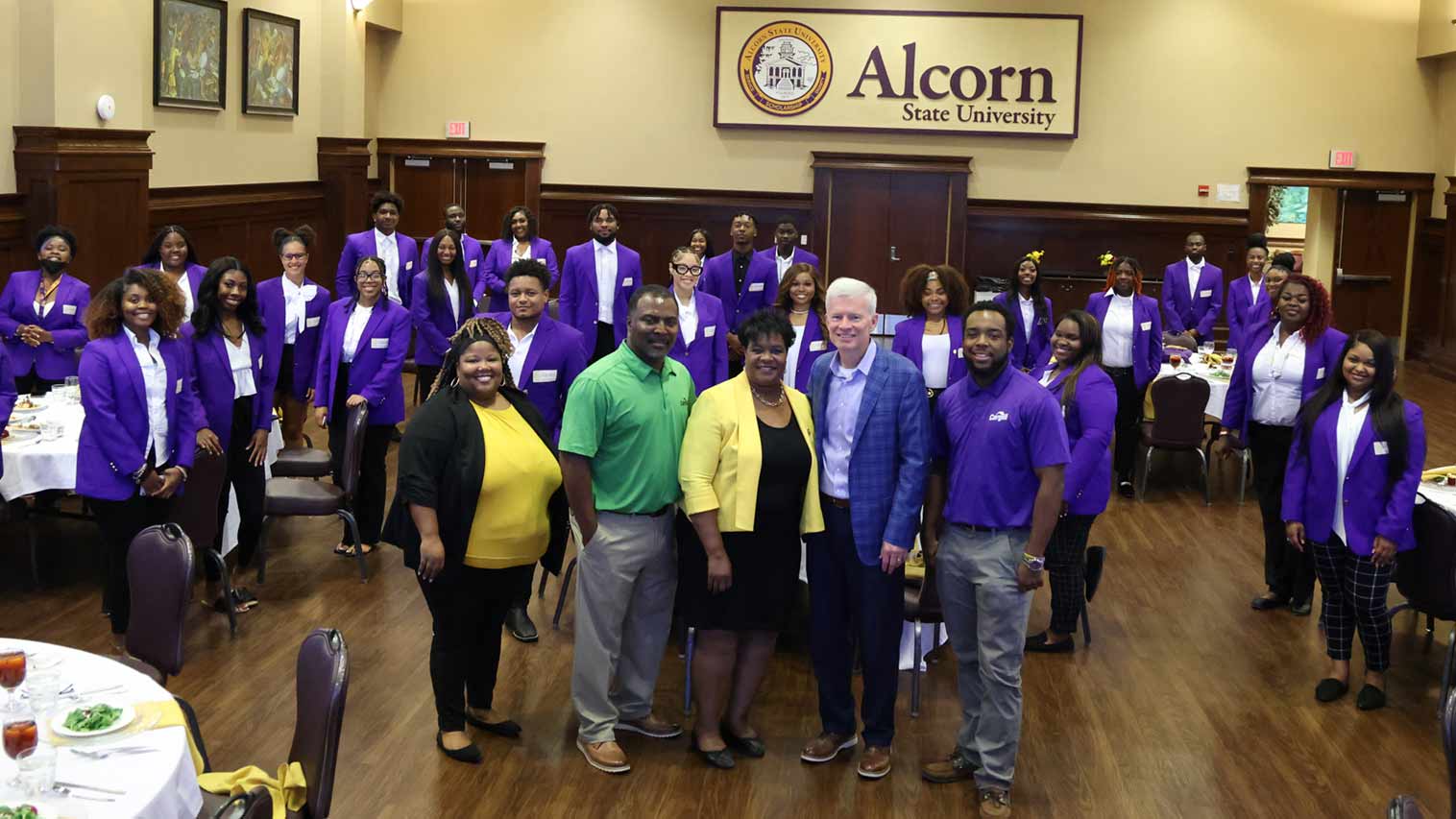 Cargill CEO Brian Sikes standing with a group of THRIVE program participants in purple blazers at Alcorn State University.
